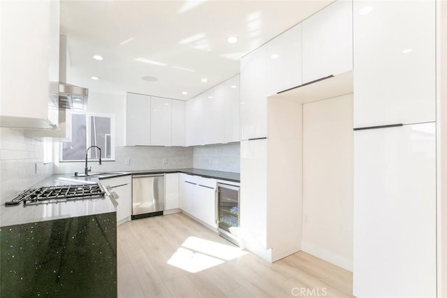 kitchen featuring a sink, wine cooler, appliances with stainless steel finishes, white cabinetry, and modern cabinets