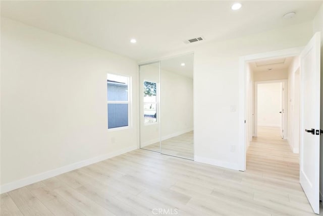 unfurnished bedroom featuring recessed lighting, visible vents, baseboards, and light wood finished floors