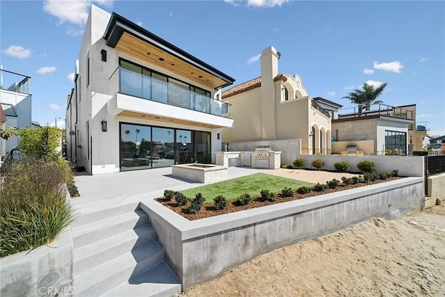 20 Balboa Cvs, Newport Beach, CA 92663 - back of property with an outdoor kitchen, a patio, a balcony, and stucco siding