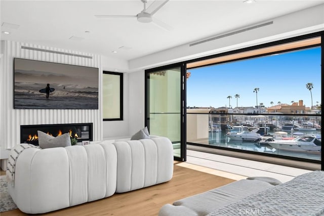 20 Balboa Cvs, Newport Beach, CA 92663 - bedroom with wood finished floors, a glass covered fireplace, and ceiling fan