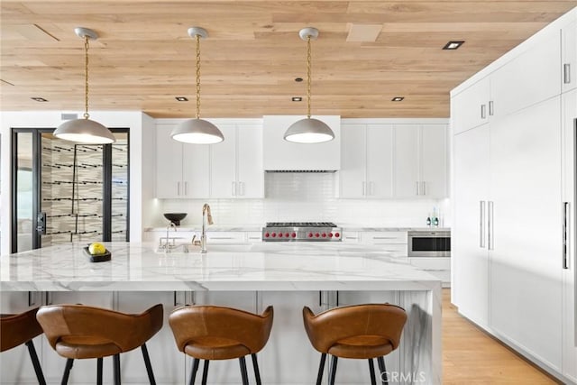 20 Balboa Cvs, Newport Beach, CA 92663 - kitchen featuring tasteful backsplash, wooden ceiling, white cabinetry, stove, and light wood-style flooring