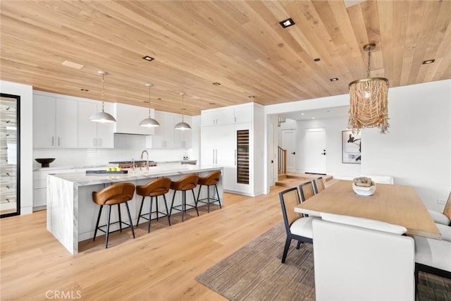 20 Balboa Cvs, Newport Beach, CA 92663 - dining room featuring light wood-style flooring and wood ceiling