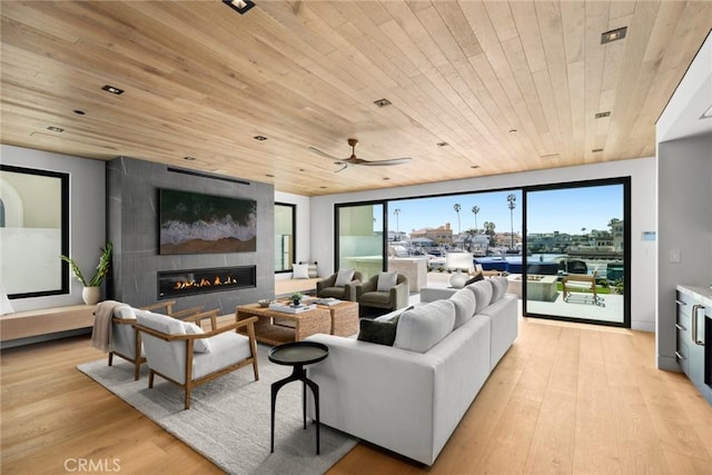 20 Balboa Cvs, Newport Beach, CA 92663 - living area with a fireplace, light wood-style floors, wood ceiling, and a ceiling fan