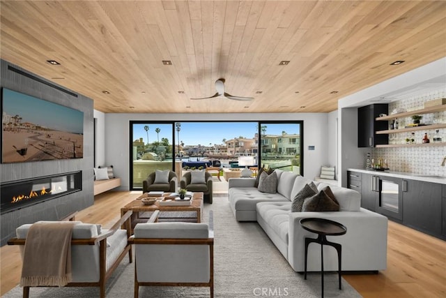 20 Balboa Cvs, Newport Beach, CA 92663 - living room featuring light wood-type flooring, wooden ceiling, a tiled fireplace, and a dry bar