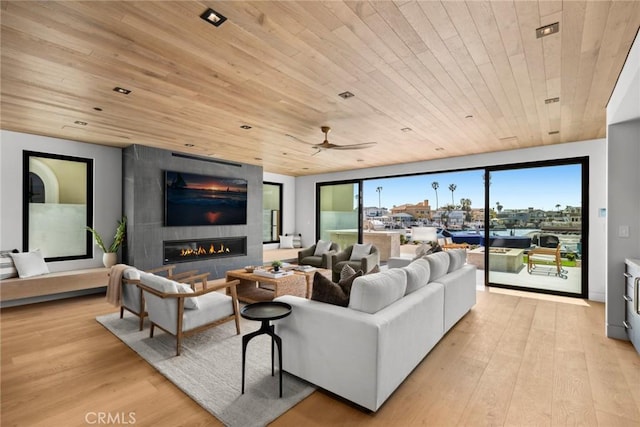 20 Balboa Cvs, Newport Beach, CA 92663 - living area with light wood-style flooring, wooden ceiling, a ceiling fan, and a large fireplace