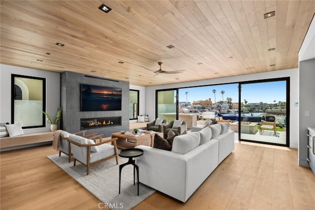 20 Balboa Cvs, Newport Beach, CA 92663 - living room with wooden ceiling, light wood-style flooring, a large fireplace, and a ceiling fan