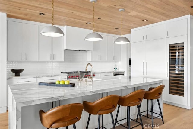 20 Balboa Cvs, Newport Beach, CA 92663 - kitchen with tasteful backsplash, light wood-type flooring, wooden ceiling, and a kitchen bar