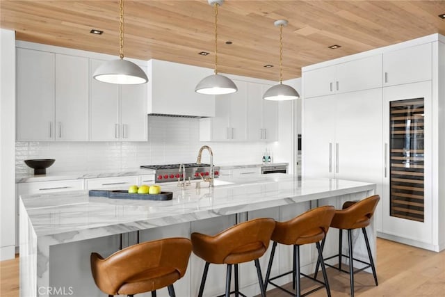 20 Balboa Cvs, Newport Beach, CA 92663 - kitchen with wood ceiling, beverage cooler, light wood-type flooring, custom exhaust hood, and a kitchen breakfast bar