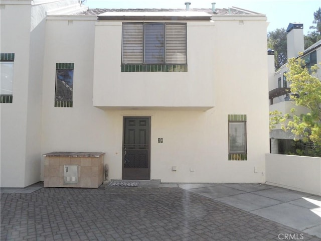 view of front of house featuring a patio area and stucco siding