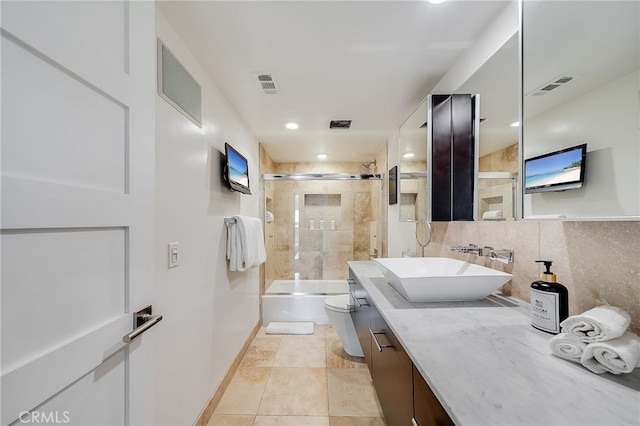 full bathroom with visible vents, toilet, vanity, and shower / bath combination with glass door