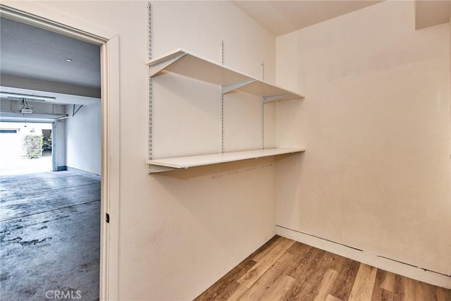 walk in closet featuring wood finished floors