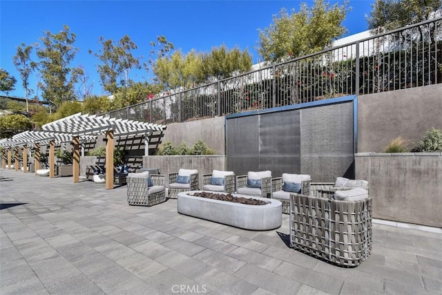 view of patio featuring fence, an outdoor living space with a fire pit, and a pergola