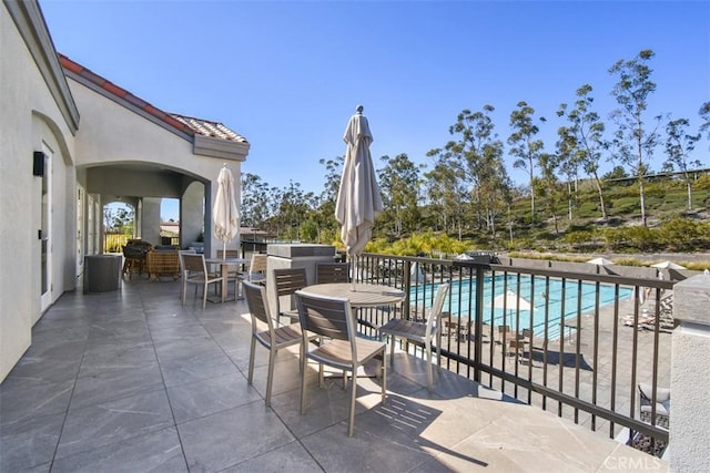 view of patio / terrace with a fenced in pool and outdoor dining area