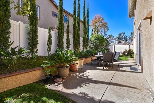 view of patio featuring outdoor dining area and a fenced backyard