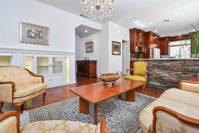 living area featuring recessed lighting, visible vents, wood finished floors, and a chandelier