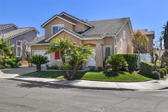 view of front of home featuring stucco siding, a tile roof, and a front yard