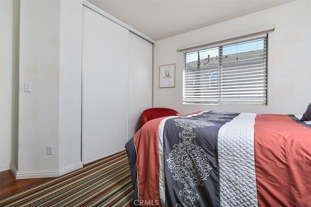 bedroom featuring a closet and baseboards