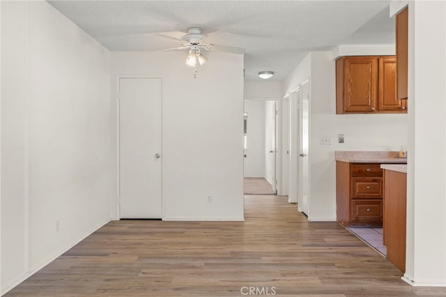 interior space with a textured ceiling and light wood finished floors