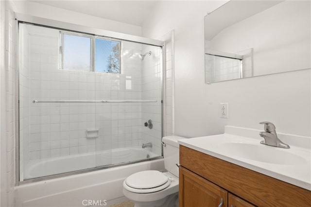 full bath with vanity, toilet, and shower / bath combination with glass door