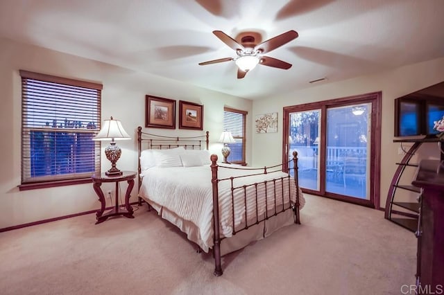 bedroom featuring a ceiling fan, baseboards, visible vents, access to exterior, and light carpet