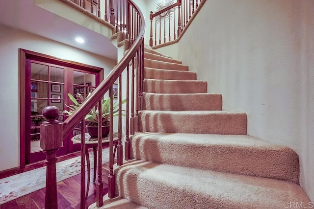 stairway featuring wood finished floors