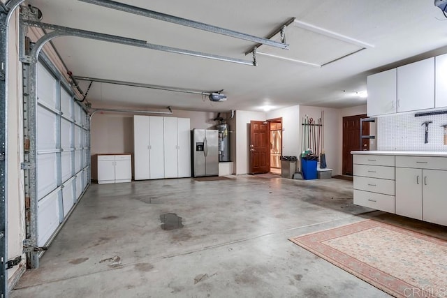 garage with gas water heater, a garage door opener, and stainless steel fridge with ice dispenser