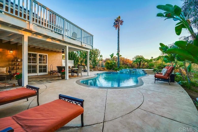 pool with a ceiling fan and a patio