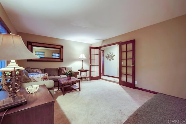 carpeted living room with french doors and baseboards