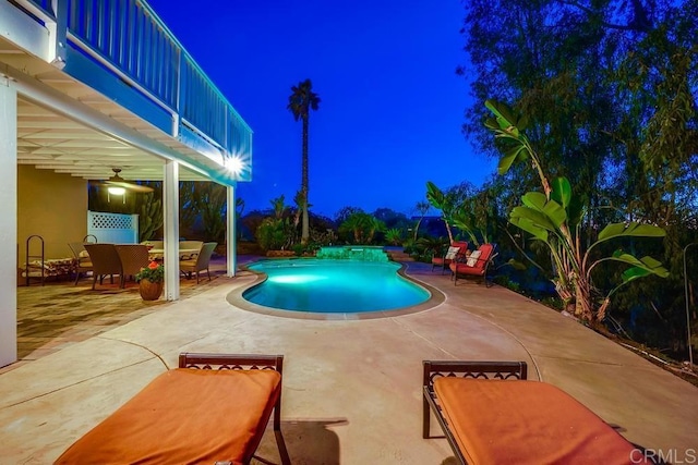 pool at twilight with an outdoor pool, a patio, and outdoor dining space