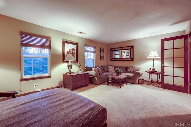 carpeted bedroom with baseboards and visible vents