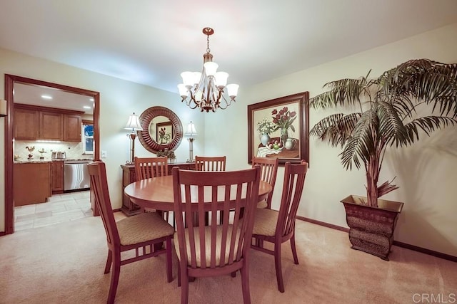 dining room with baseboards, light carpet, and a notable chandelier