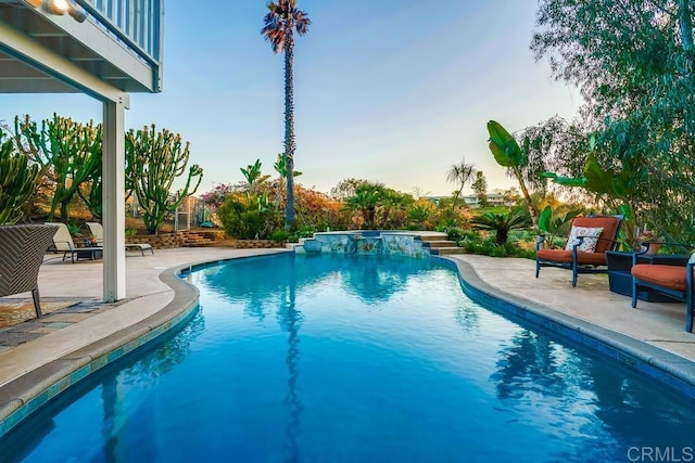 pool featuring a patio area and a hot tub