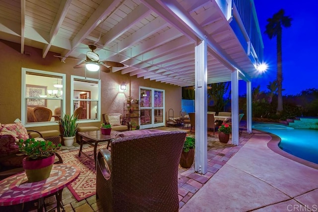 patio at twilight featuring a ceiling fan and an outdoor pool