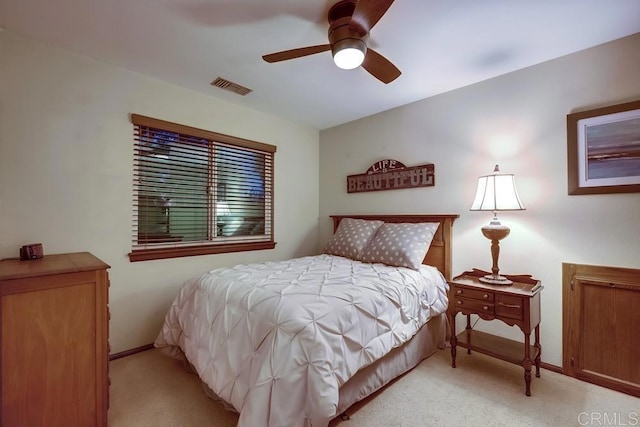 bedroom with ceiling fan, baseboards, visible vents, and light carpet