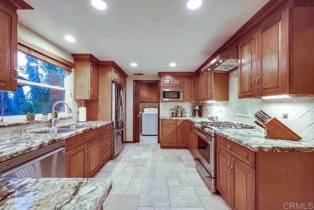 kitchen with a sink, decorative backsplash, appliances with stainless steel finishes, and brown cabinetry