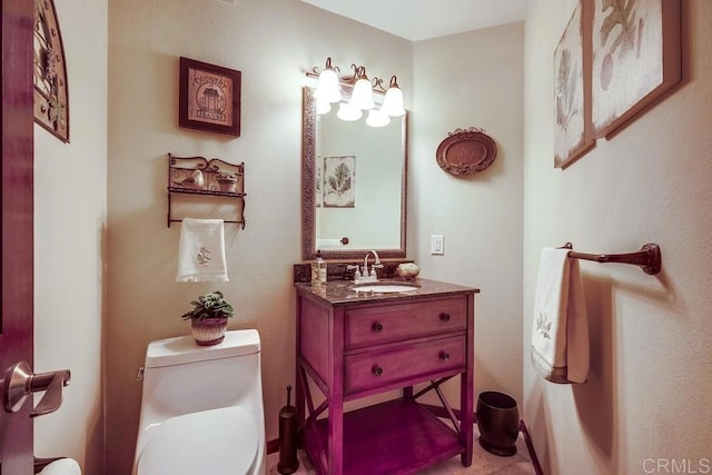 half bathroom featuring toilet and vanity