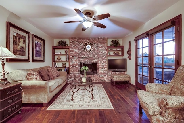 living room featuring a fireplace, dark wood-type flooring, and a ceiling fan