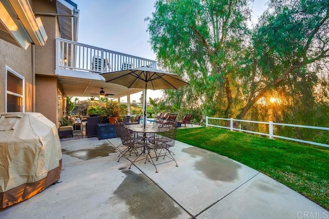 view of patio with grilling area, outdoor dining area, and a balcony