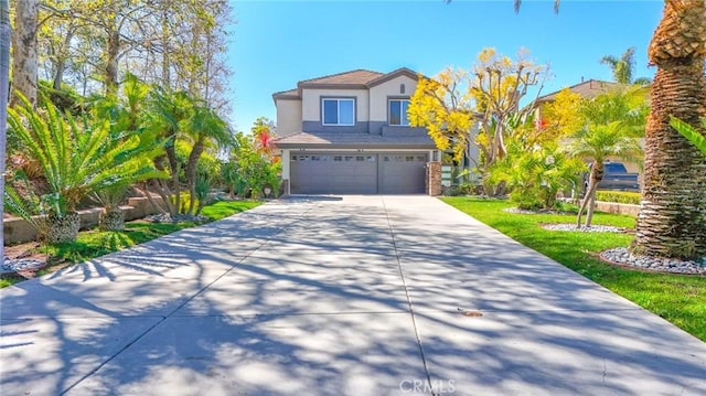 view of front facade featuring a garage, driveway, and stucco siding