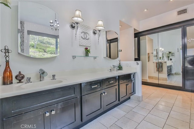 full bath featuring tile patterned floors, double vanity, visible vents, and a sink