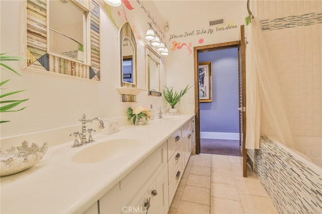 full bathroom with visible vents, a sink, tile patterned flooring, double vanity, and baseboards