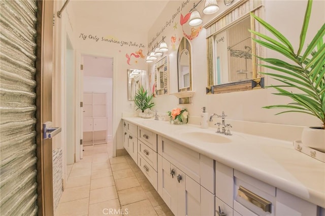 bathroom featuring double vanity, tile patterned floors, and a sink