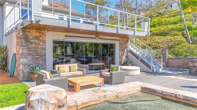 view of patio / terrace with stairway, a balcony, an outdoor hangout area, and a garage