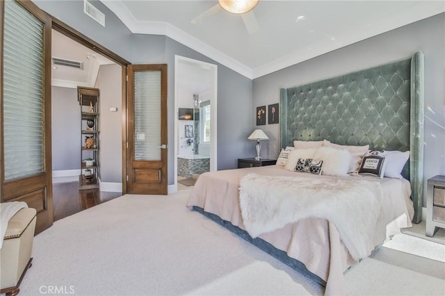 bedroom with vaulted ceiling, visible vents, wood finished floors, and ornamental molding