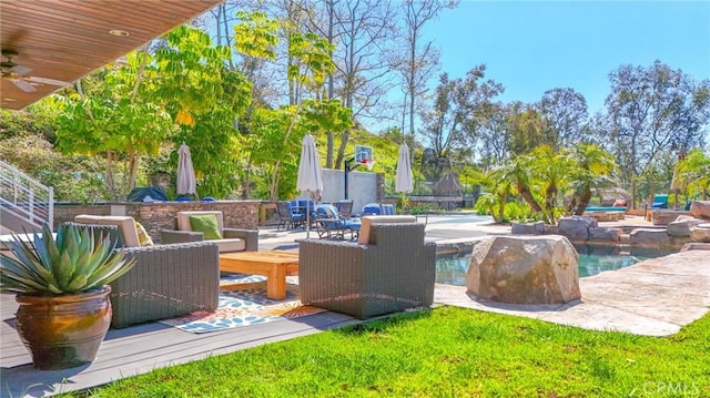 view of patio / terrace with an outdoor pool and ceiling fan