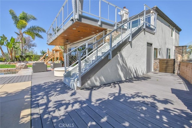 deck featuring stairway, a patio, an outdoor hangout area, and a ceiling fan