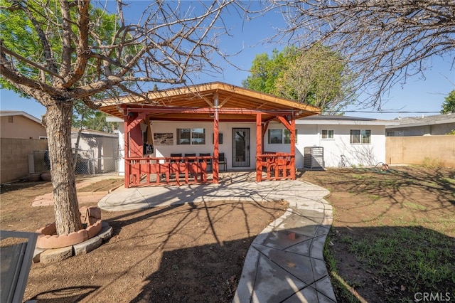 rear view of property with fence