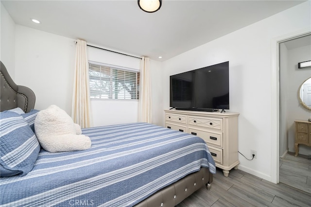 bedroom featuring wood finish floors, baseboards, and recessed lighting