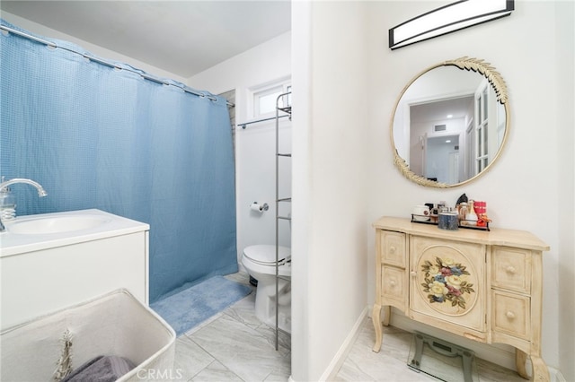 full bathroom featuring toilet, marble finish floor, and vanity