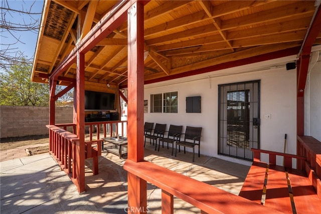 view of patio / terrace featuring outdoor lounge area and fence